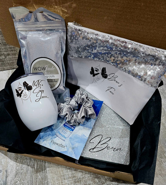 Collection of beauty products including a white container, scrunchies, and a pouch with 'Bern' branding on a textured surface.