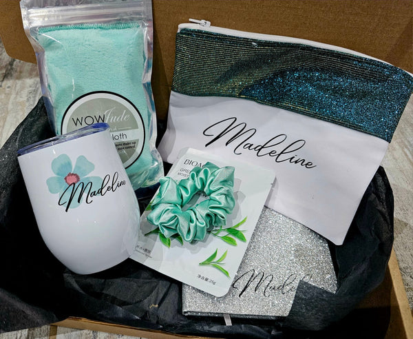 Collection of items including a tumbler, pouch, scrunchie, and packaging with 'Madeline' branding.