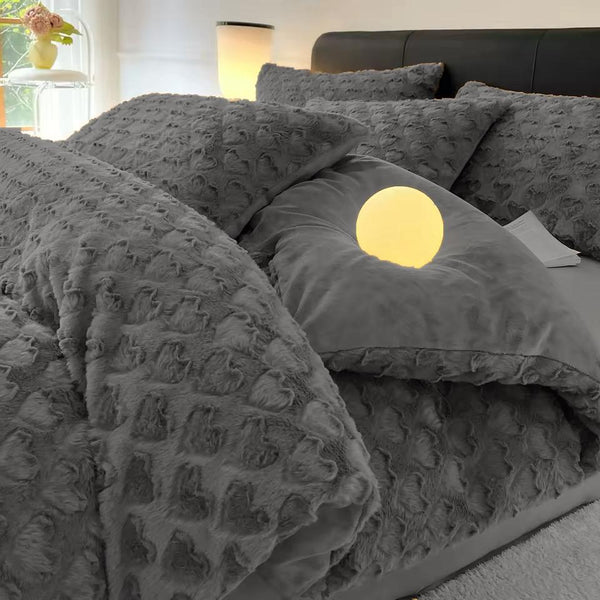 Gray textured bedding set with a moon pillow on a bed in a bedroom.