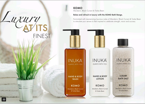 A promotional image for Komo's Luxury Range, featuring a hand and body lotion, wash, and bath salt products with a decorative background.