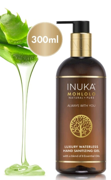 A pump bottle of INNULA Mohlolo Hand Sanitizing Gel, with a volume of 300ml, displayed next to a glass of water and a potted plant, against a white background.